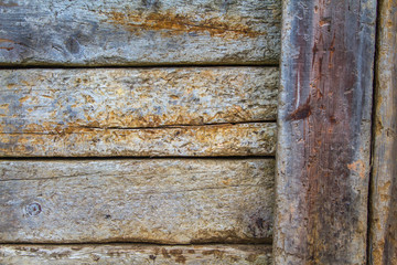 Part of a fence with vertical planks on the right. Wood details are clearly visible. Nice degraded colors.