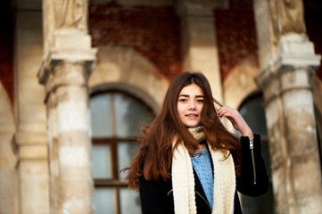 The wind in your hair. Young girl looking at the camera. Long dark and brown eyes .