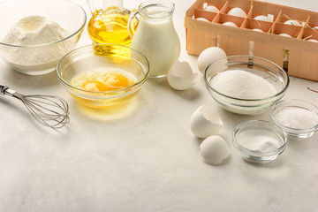 Fototapeta na wymiar Ingredients for making pancakes on a white background. Copy space.