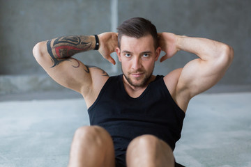 Obraz premium Young man fitness workout, sit-up crunches for abs