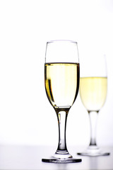glass of white wine on a table on white background isolate