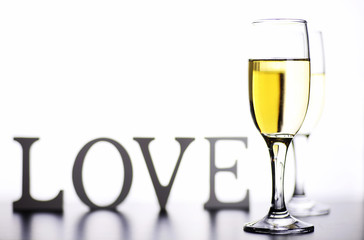 glass of white wine on a table on white background isolate
