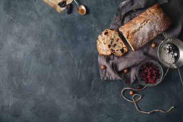 Baked cake with dried fruits and nuts on rustic background. Top view with copy space.