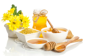 Yellow flowers and bee products (honey, pollen) isolated on white background