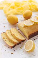 lemon cake with fruits on white wooden surface