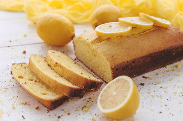 lemon cake with fruits on white wooden surface