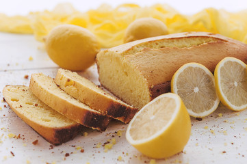 lemon cake with fruits on white wooden surface