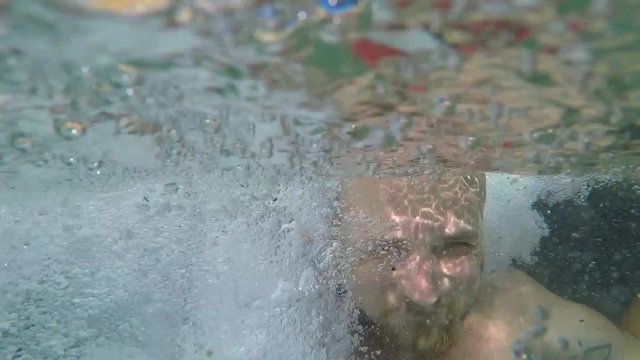 Young Bearded Man Smiling Under Waterfall at Emerald Pool Pond with Blue Water. Slow Motion Gopro HD Selfie. Thailand.