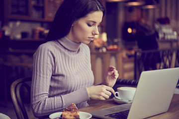woman working with laptop in cafe. social network concept