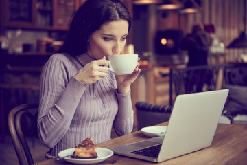 woman working with laptop in cafe. social network concept