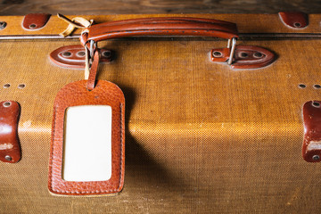 Old suitcase with blank label. Top view. copy space