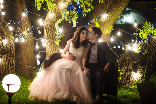 wedding couple in magical night forest decorated light garlands