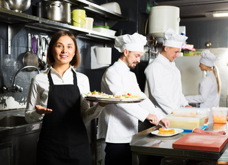 Obraz na płótnie Canvas Waitress in restaurant kitchen