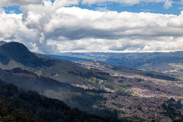 Fototapeta na wymiar The suburbs of Bogota rise up into the mountains near the Candelaria Neighborhood.