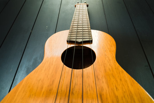 ukulele with black wall background