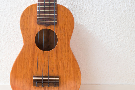 ukulele with white wall background