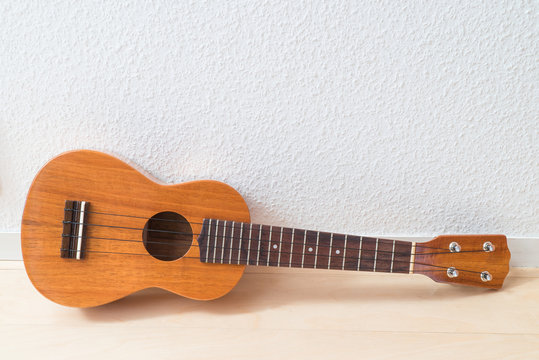 ukulele with white wall background