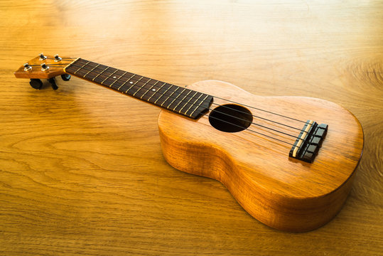 ukulele on a wooden table