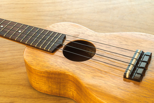 ukulele on a wooden table