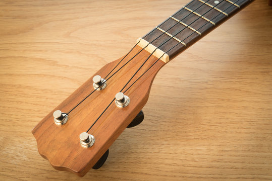ukulele on a wooden table