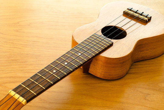 ukulele on a wooden table