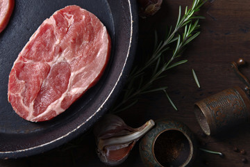 Pork steak with rosemary, garlic and pepper , top view