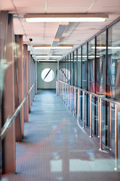 Long passages for boarding are in airports. Metal and glass constructions