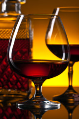  glasses of brandy on the reflective background