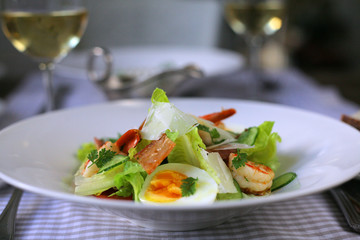 salad with lettuce, basil, bacon, egg and shrimps