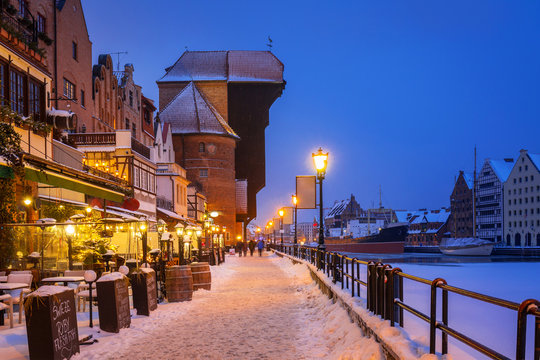 Medieval port crane at Motława river in snowy Gdansk, Poland