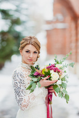 Close-up portrait of a bride with the beautiful bridal bouquet