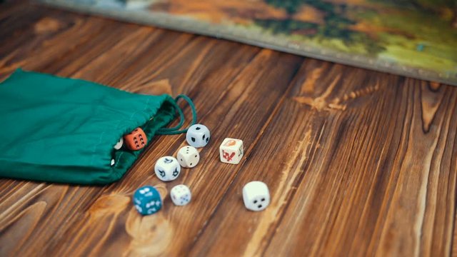 Dices Fall On a Wooden Table With Boardgame