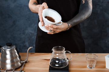 Male barista brewing coffee. Alternative method pour over.