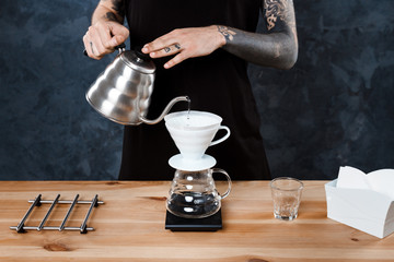 Male barista brewing coffee. Alternative method pour over.