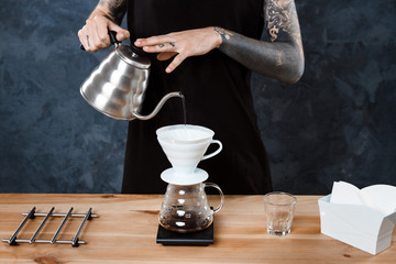 Male barista brewing coffee. Alternative method pour over.