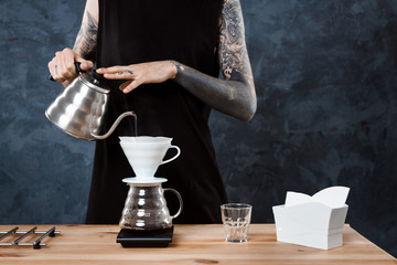 Male barista brewing coffee. Alternative method pour over.