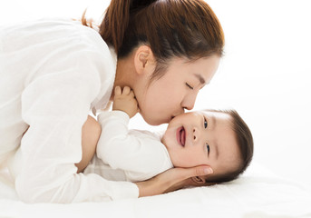 Obraz na płótnie Canvas young Mother kissing sweet baby boy
