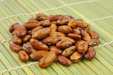 Brown pinto beans on bamboo mat