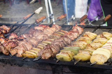 BBQ meat and potato on grill