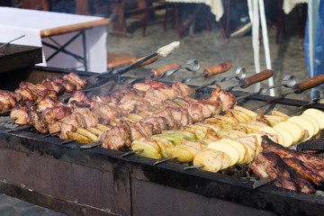 BBQ meat and potato on grill