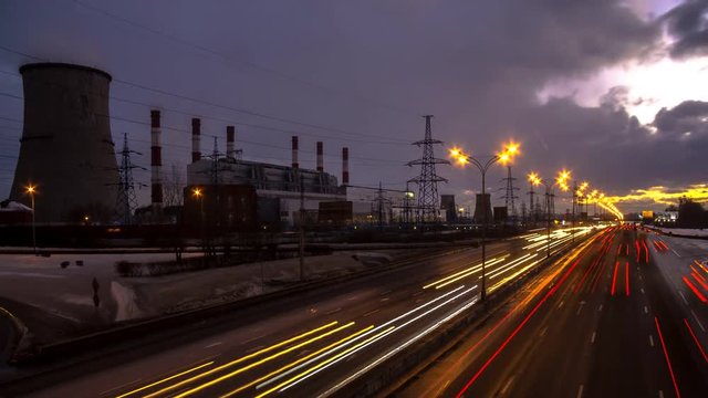 time lapse video of night traffic on urban thoroughfare along industrial zone 

