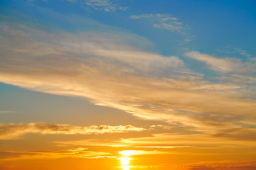 Sunset sky orange clouds over blue