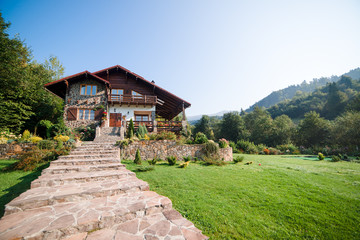 Fototapeta na wymiar Beautiful house in high mountains during summer.