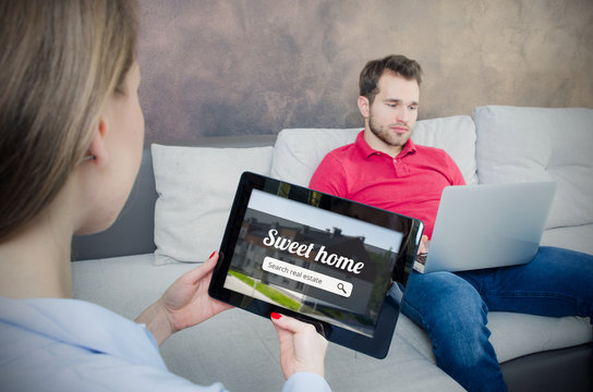 Young couple looking on the internet your own home