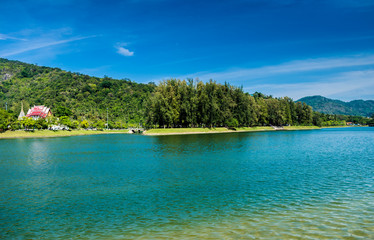 Beautiful river park trees green grass over blue sky