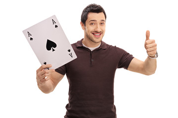 Guy holding ace of spades card and giving thumb up