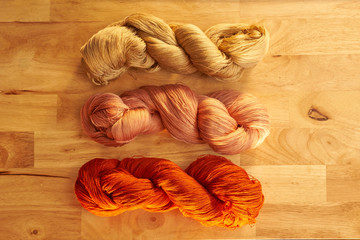 Colourful pure silk cotton on the pattern brown wood.