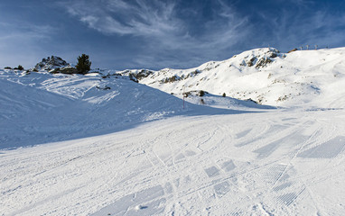 View of an alpine ski slope in mountains