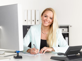 Female office assistant has a call at the office