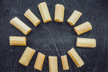 Pieces of cane sugar on the old wooden background. Sugar concept